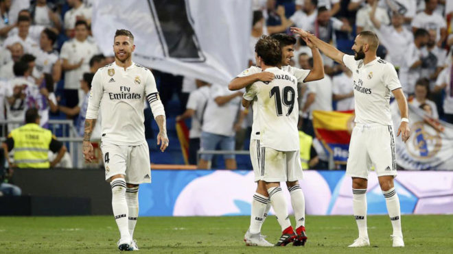 Real Madrid players celebrate Asensio&apos;s goal.