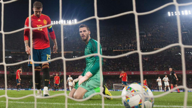 Spain&apos;s goalkeeper David de Gea eyes the ball scored by  England&apos;s...