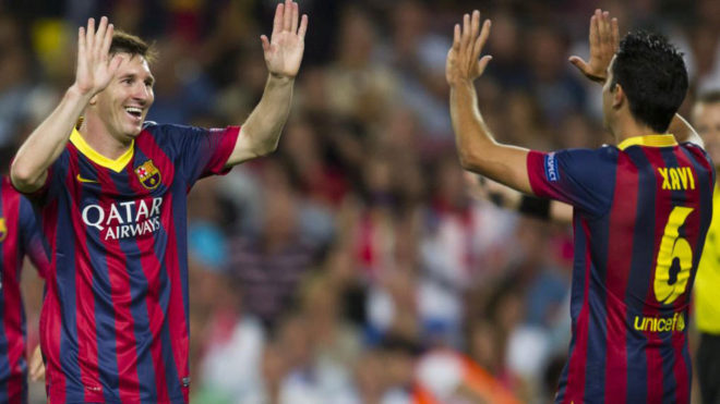 Leo Messi and Xavi Hernandez celebrate a goal for Barcelona.