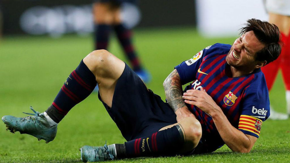 Messi gestures in pain during the Spanish league football match FC...
