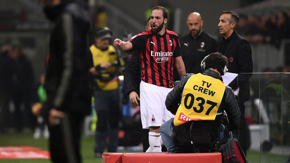 Higuain reacts from the side of the pitch after he received a red card...