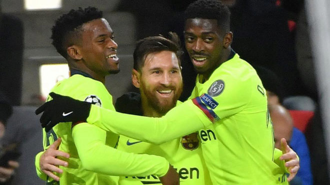 Messi celebrates with Dembele and Semedo after scoring during the...