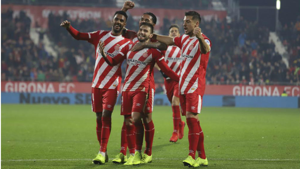 Girona&apos;s players celebrate a goal.