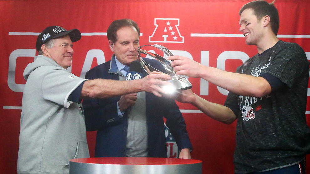 Tom Brady y Bill Belichick reciben el trofeo de campeones de la AFC.