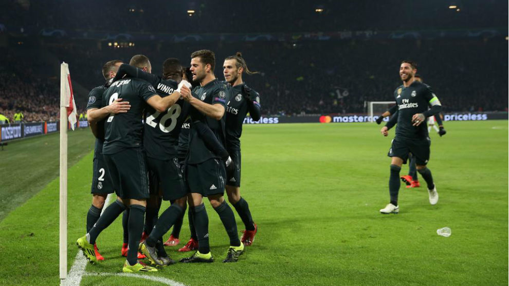 The Real Madrid players celebrate scoring against Ajax.