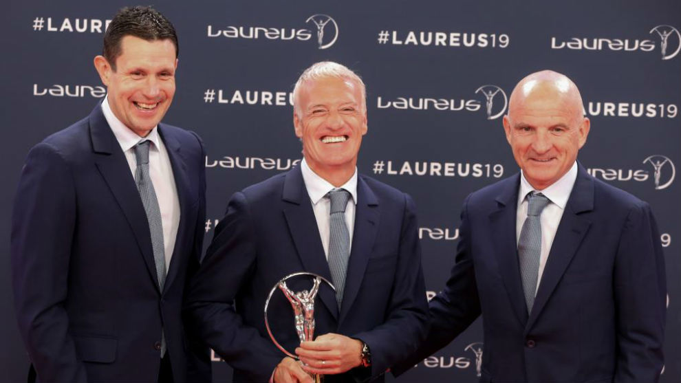 Didier Deschamps receives the award on behalf of the French World Cup...