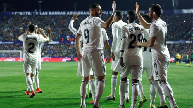 Benzema celebrates with teammates after scoring a goal during the...