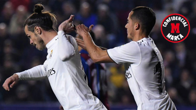 Gareth Bale shrugs Lucas Vazquez away.