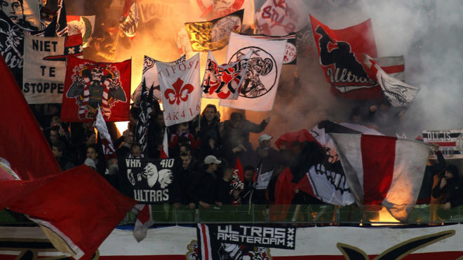 The Ajax supporters with flags.