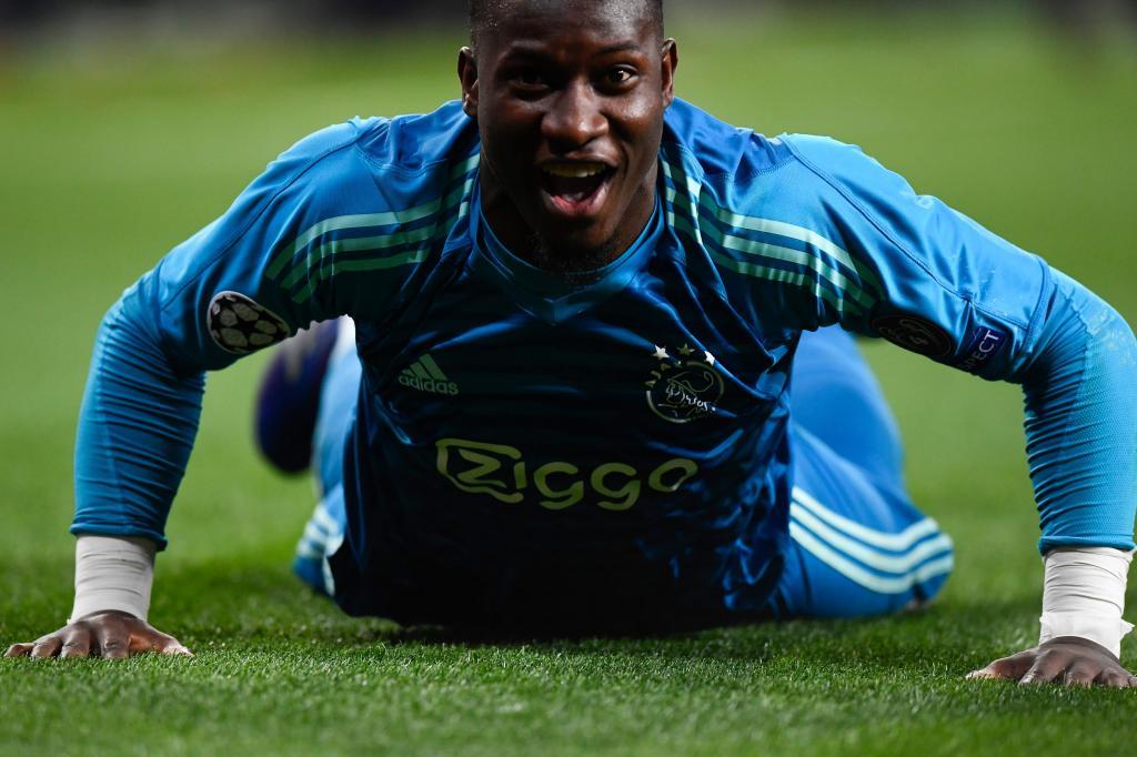 Ajaxs Cameroonian goalkeeper Andre <HIT>Onana</HIT> celebrates at the end of the UEFA Champions League round of 16 second leg football match between Real Madrid CF and Ajax at the Santiago Bernabeu stadium in Madrid on March 5, 2019. (Photo by GABRIEL BOUYS / AFP)