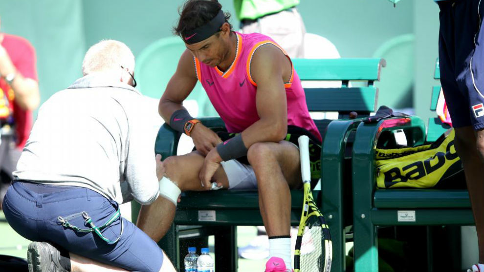 Nadal having his knee seen to.
