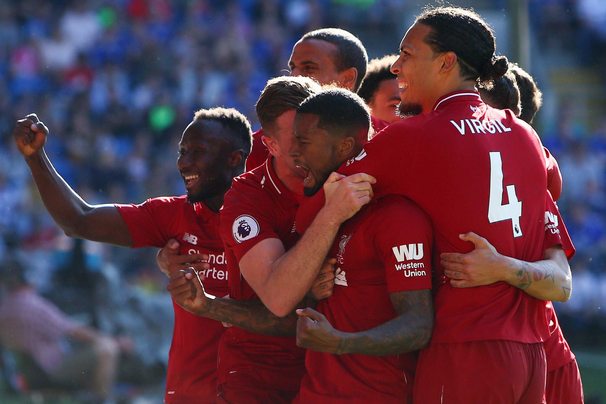 TOPSHOT - <HIT>Liverpool</HIT>s Dutch midfielder Georginio Wijnaldum (C) celebrates scoring the opening goal during the English Premier League football match between between Cardiff City and <HIT>Liverpool</HIT> at Cardiff City Stadium in Cardiff, south Wales on April 21, 2019. (Photo by GEOFF CADDICK / AFP) / RESTRICTED TO EDITORIAL USE. No use with unauthorized audio, video, data, fixture lists, club/league logos or live services. Online in-match use limited to 120 images. An additional 40 images may be used in extra time. No video emulation. Social media in-match use limited to 120 images. An additional 40 images may be used in extra time. No use in betting publications, games or single club/league/player publications. /