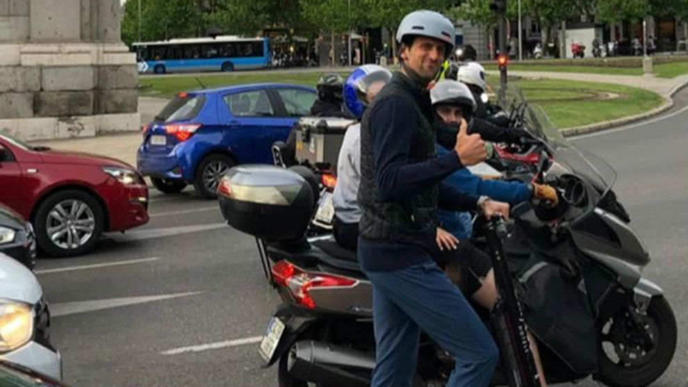 Djokovic travels through Madrid on a scooter.
