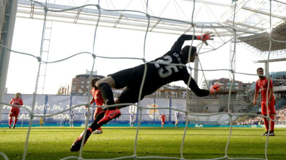 Thibaut Courtois stretches to save an Adnan Januzaj shot in the second...