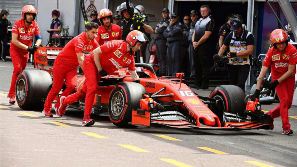 Los mecnicos de Ferrari empujando a leclerc tras saltarse el pesaje.