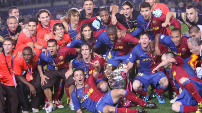 The Barcelona players pose with the Champions League after their...