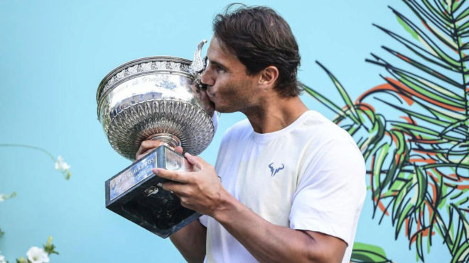 Rafa Nadal kissing his 12th Roland Garros trophy.