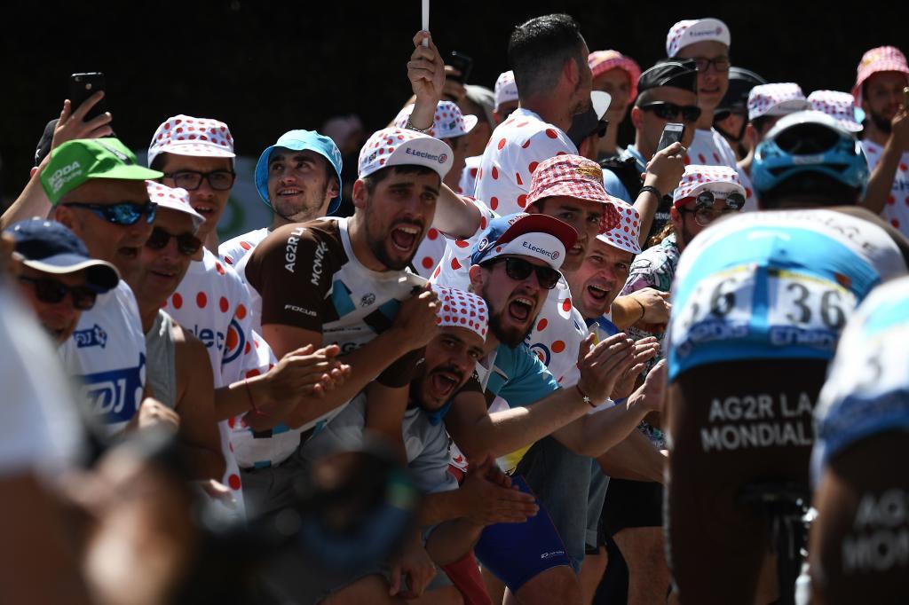 Cyclism enthusiasts cheer riders of Frances AG2R La Mondiale cycling team during the eighth stage of the 106th edition of the <HIT>Tour</HIT> de France cycling race between Macon and Saint-Etienne, on July 13, 2019. (Photo by Anne-Christine POUJOULAT / AFP)