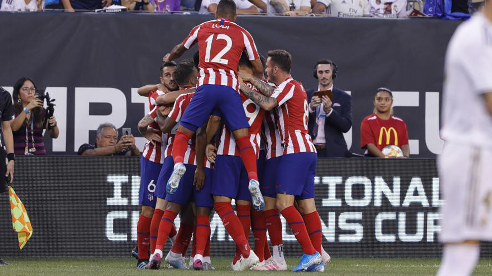 Saul Niguez celebrates one of Atletico Madrid&apos;s goals with his...