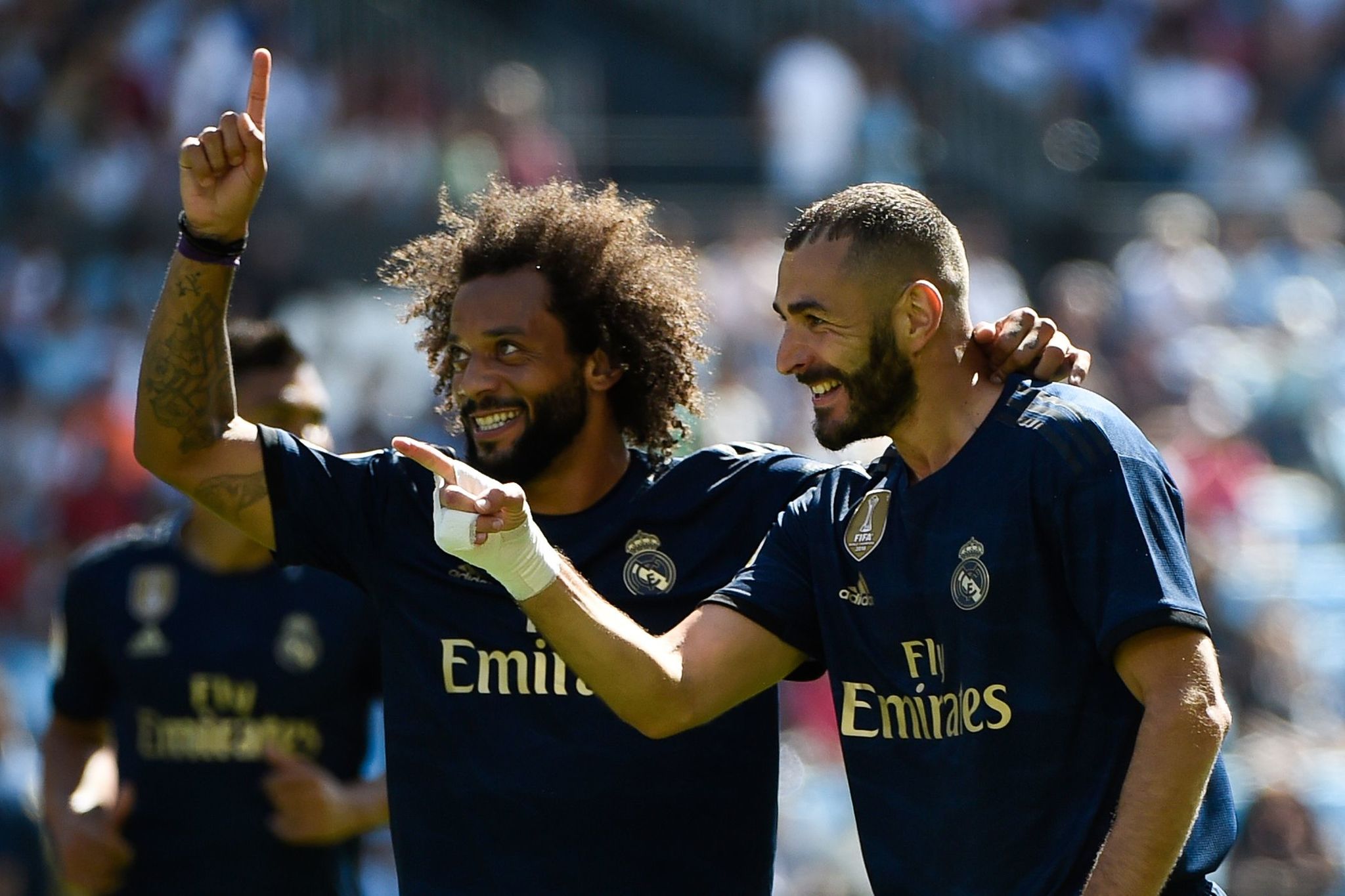 Real Madrids French forward Karim Benzema (R) celebrates with Real Madrids Brazilian defender <HIT>Marcelo</HIT> after scoring a goal during the Spanish League football match between Celta Vigo and Real Madrid at the Balaidos Stadium in Vigo on August 17, 2019. (Photo by MIGUEL RIOPA / AFP)