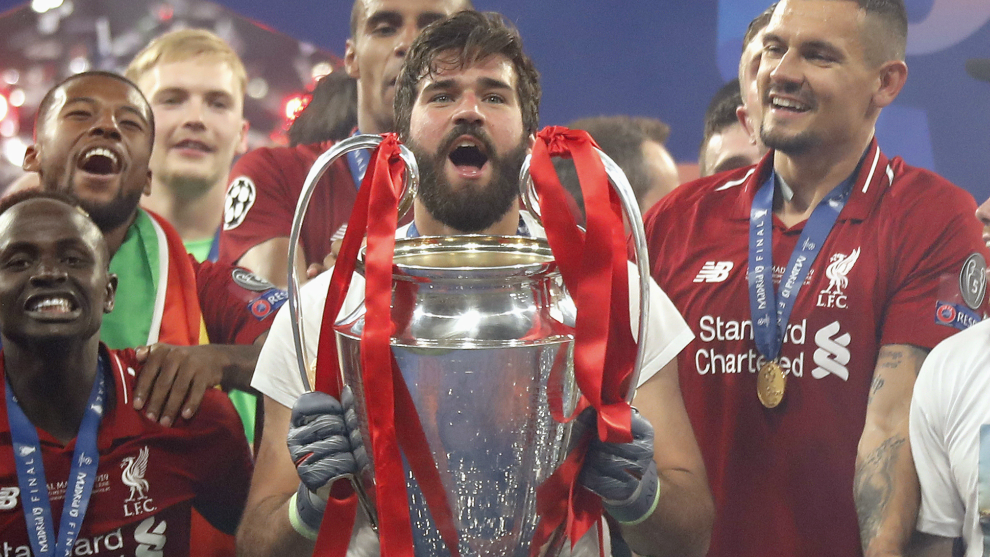 Alisson lifting the Champions League with Liverpool last season.
