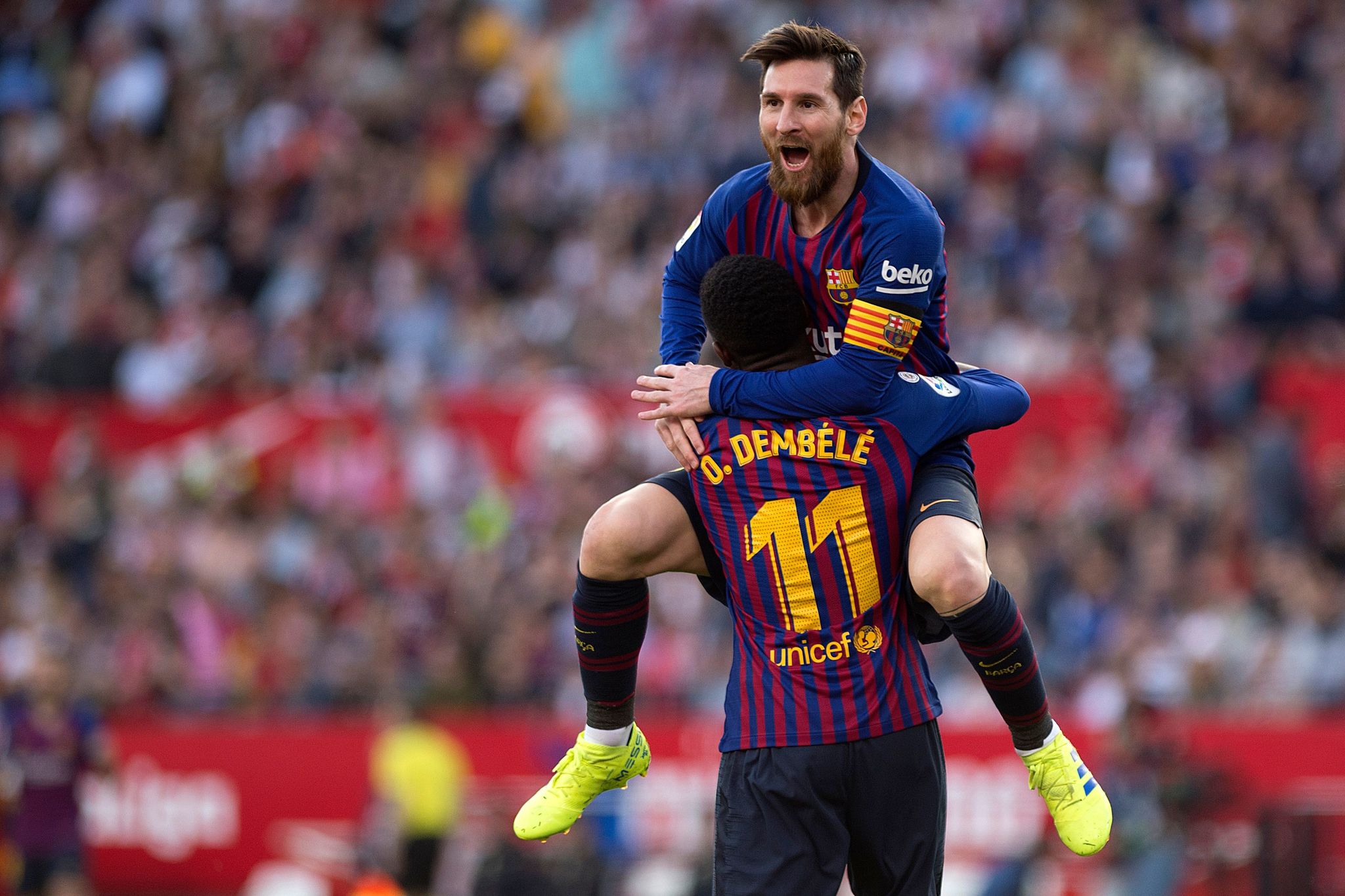 TOPSHOT - Barcelonas Argentinian forward Lionel <HIT>Messi</HIT> (back) celebrates with Barcelonas French forward Ousmane <HIT>Dembele</HIT> after scoring a goal during the Spanish league football match between Sevilla FC and FC Barcelona at the Ramon Sanchez Pizjuan stadium in Sevilla on February 23, 2019. (Photo by JORGE GUERRERO / AFP)