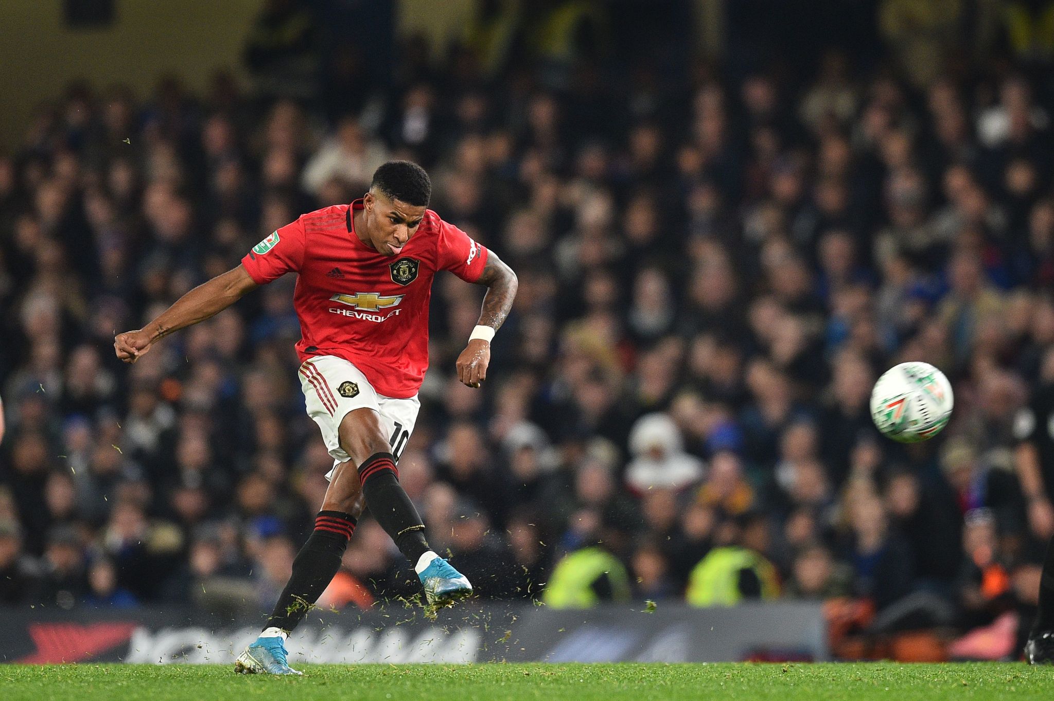 Manchester Uniteds English striker Marcus <HIT>Rashford</HIT> takes a penalty and scores his teams second goal during the English League Cup fourth round football match between Chelsea and Manchester United at Stamford Bridge in London on October 30, 2019. (Photo by Glyn KIRK / AFP) / RESTRICTED TO EDITORIAL USE. No use with unauthorized audio, video, data, fixture lists, club/league logos or live services. Online in-match use limited to 75 images, no video emulation. No use in betting, games or single club/league/player publications. /