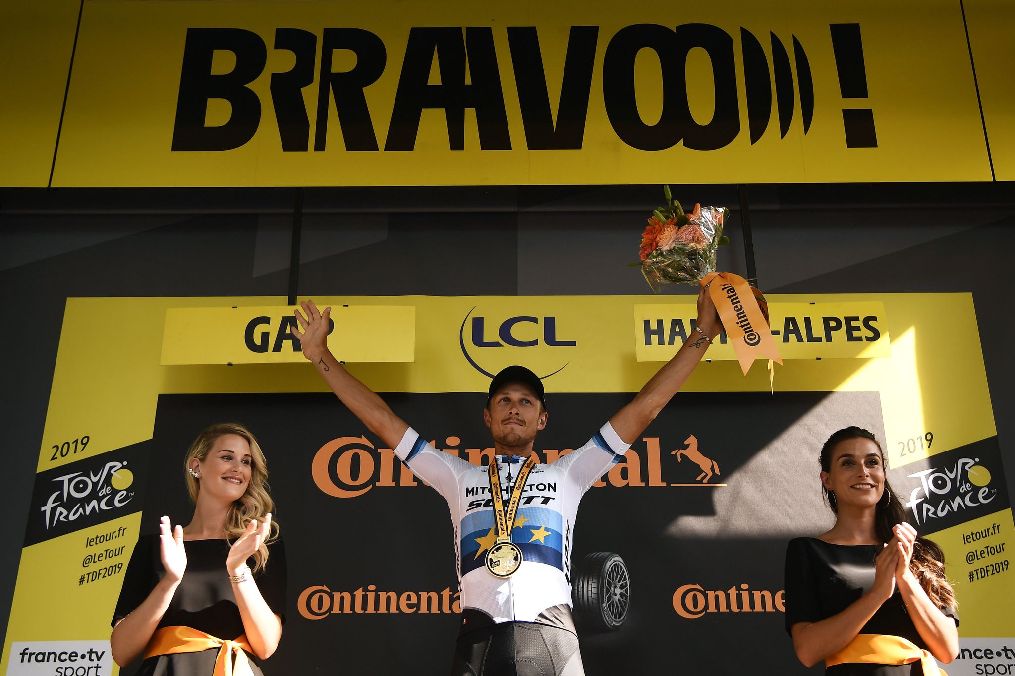 Stage winner Italys Matteo <HIT>Trentin</HIT> (C) celebrates his victory on the podium of the sixteenth stage of the 106th edition of the Tour de France cycling race between Nimes and Nimes, in Nimes, on July 23, 2019. (Photo by Marco Bertorello / AFP)