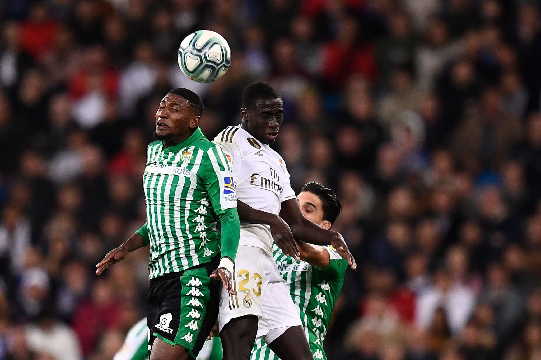 TOPSHOT - Real <HIT>Betis</HIT> Brazilian defender Emerson Aparecido (L) heads the ball next to Real <HIT>Betis</HIT> Algerian defender Aissa Mandi (C) during the Spanish League football match between Real Madrid CF and Real <HIT>Betis</HIT> at the Santiago <HIT>Bernabeu</HIT> stadium in Madrid, on November 2, 2019. (Photo by OSCAR DEL POZO / AFP)