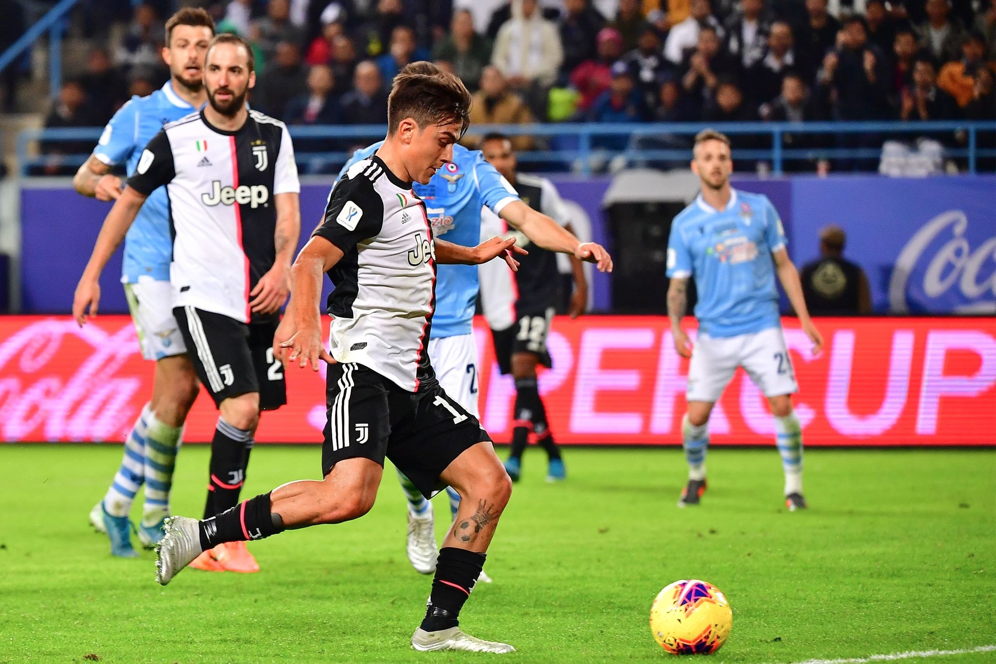 Juventus Argentine forward Paulo <HIT>Dybala</HIT> shoots to score during the Supercoppa Italiana final football match between Juventus and Lazio at the King Saud University Stadium in the Saudi capital Riyadh on December 22, 2019. (Photo by GIUSEPPE CACACE / AFP)