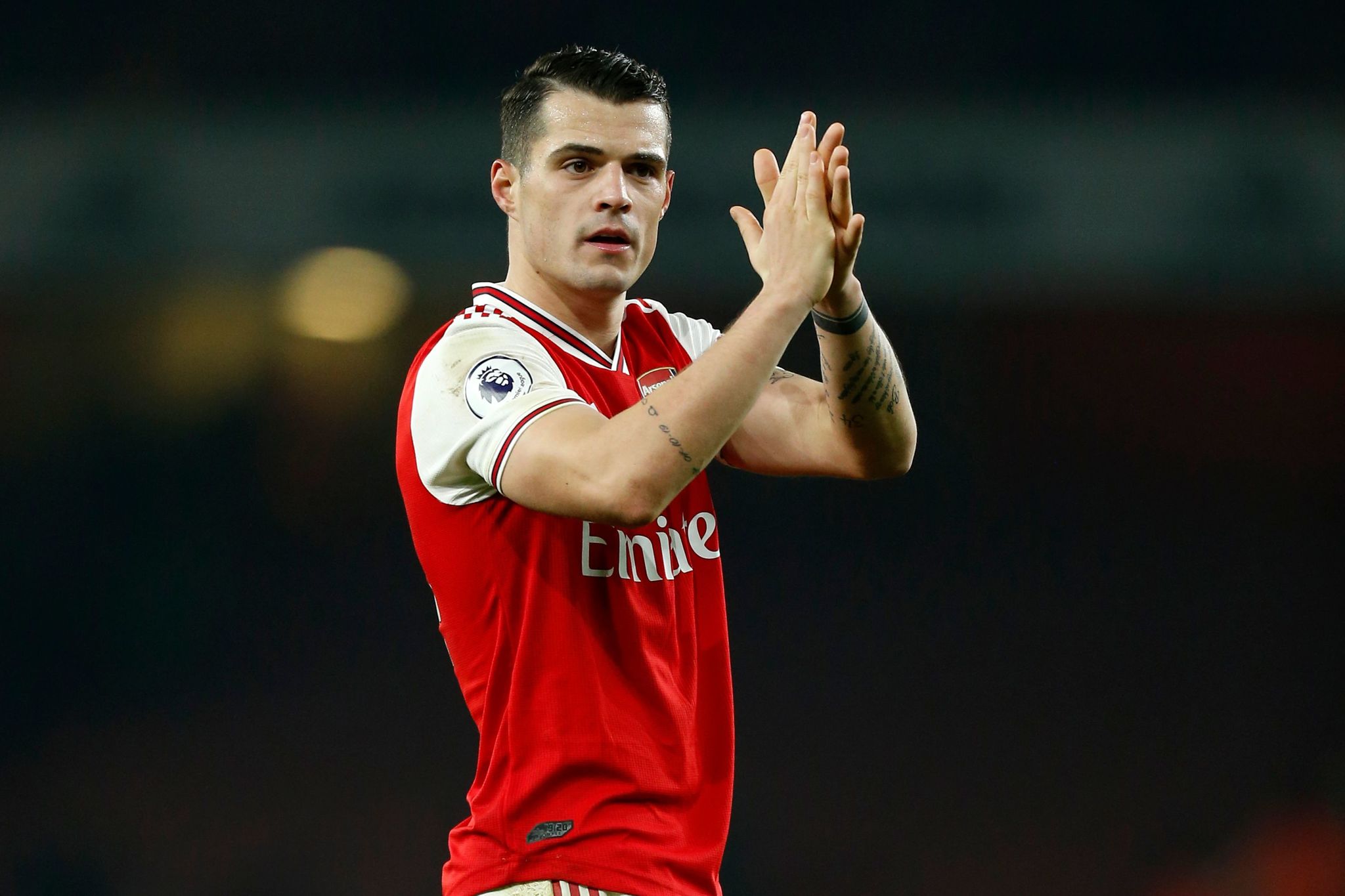 Arsenals Swiss midfielder Granit <HIT>Xhaka</HIT> applauds supporters on the pitch after the English Premier League football match between Arsenal and Manchester United at the Emirates Stadium in London on January 1, 2020. - Arsenal won the game 2-0. (Photo by Ian KINGTON / IKIMAGES / AFP) / RESTRICTED TO EDITORIAL USE. No use with unauthorized audio, video, data, fixture lists, club/league logos or live services. Online in-match use limited to 45 images, no video emulation. No use in betting, games or single club/league/player publications