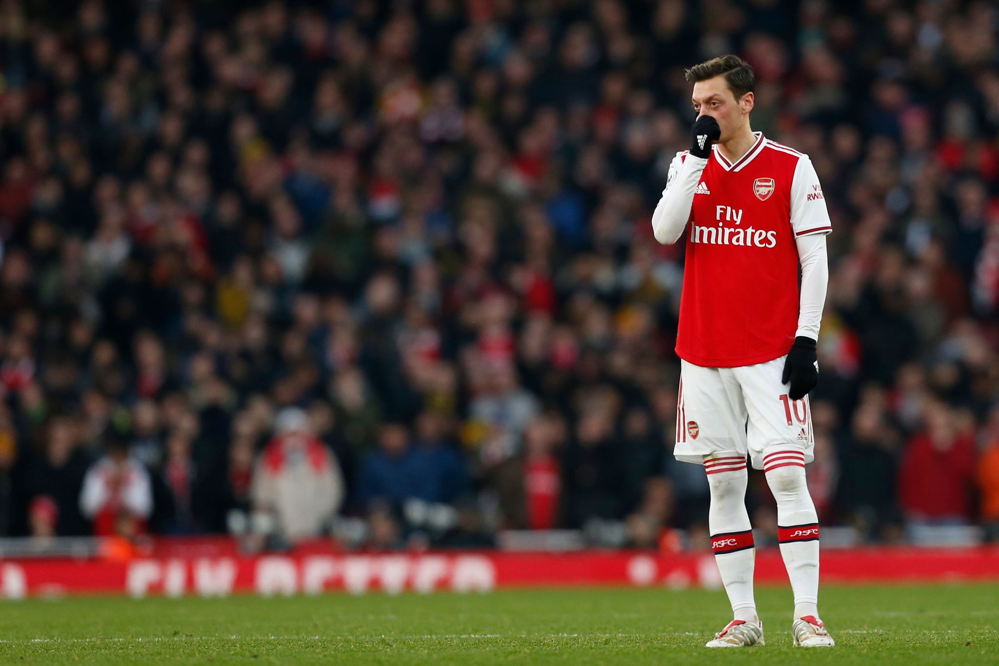 Arsenals German midfielder Mesut <HIT>Ozil</HIT> reacts during the English Premier League football match between Arsenal and Chelsea at the Emirates Stadium in London on December 29, 2019. (Photo by Ian KINGTON / IKIMAGES / AFP) / RESTRICTED TO EDITORIAL USE. No use with unauthorized audio, video, data, fixture lists, club/league logos or live services. Online in-match use limited to 45 images, no video emulation. No use in betting, games or single club/league/player publications