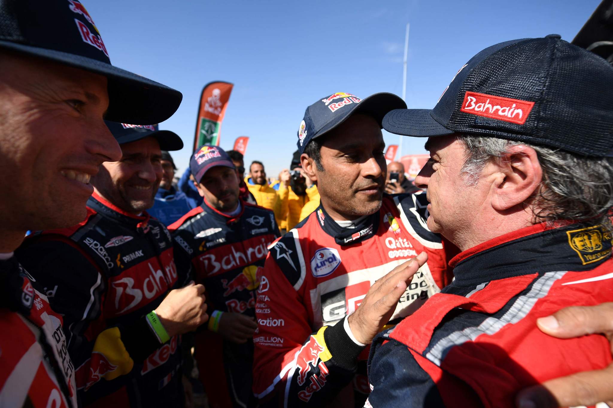 First-placed for the auto category JCW X-RAID Mini Team Spains driver Carlos <HIT>Sainz</HIT> (R), is congratulated by second-placed Toyotas team Qatars driver Nasser Al-Attiyah (C) on the finish area in Qiddiya at the end of the stage 12 of the Dakar 2020 between Haradh and Qiddiya, Saudi Arabia, on January 17, 2020. (Photo by FRANCK FIFE / AFP)