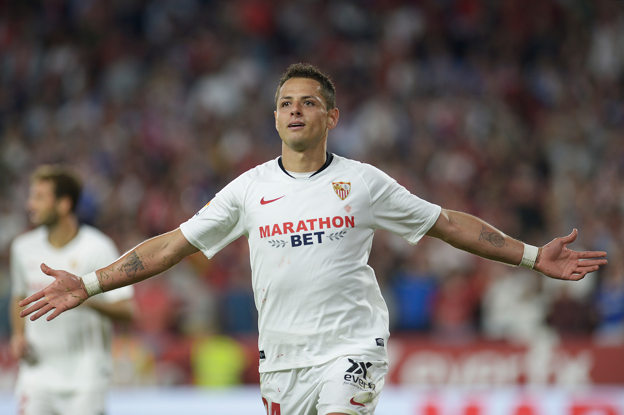 (FILES) In this file photo taken on October 27, 2019 Sevillas Mexican forward <HIT>Chicharito</HIT> celebrates after scoring a goal during the Spanish league football match between Sevilla FC and Getafe CF at the Ramon Sanchez Pizjuan stadium in Seville. - The Los Angeles Galaxy have signed Mexico striker Javier "<HIT>Chicharito</HIT>" Hernandez from Sevilla and will make him the highest-paid player in Major League Soccer, Sports Illustrated reported January 17, 2020. Galaxy will be counting on <HIT>Chicharito</HIT>, who is Mexicos all-time leading goal-scorer, to fill the star-power and scoring void left by the departure of Zlatan Ibrahimovic, the Swedish star who returned to AC Milan in December. (Photo by CRISTINA QUICLER / AFP)