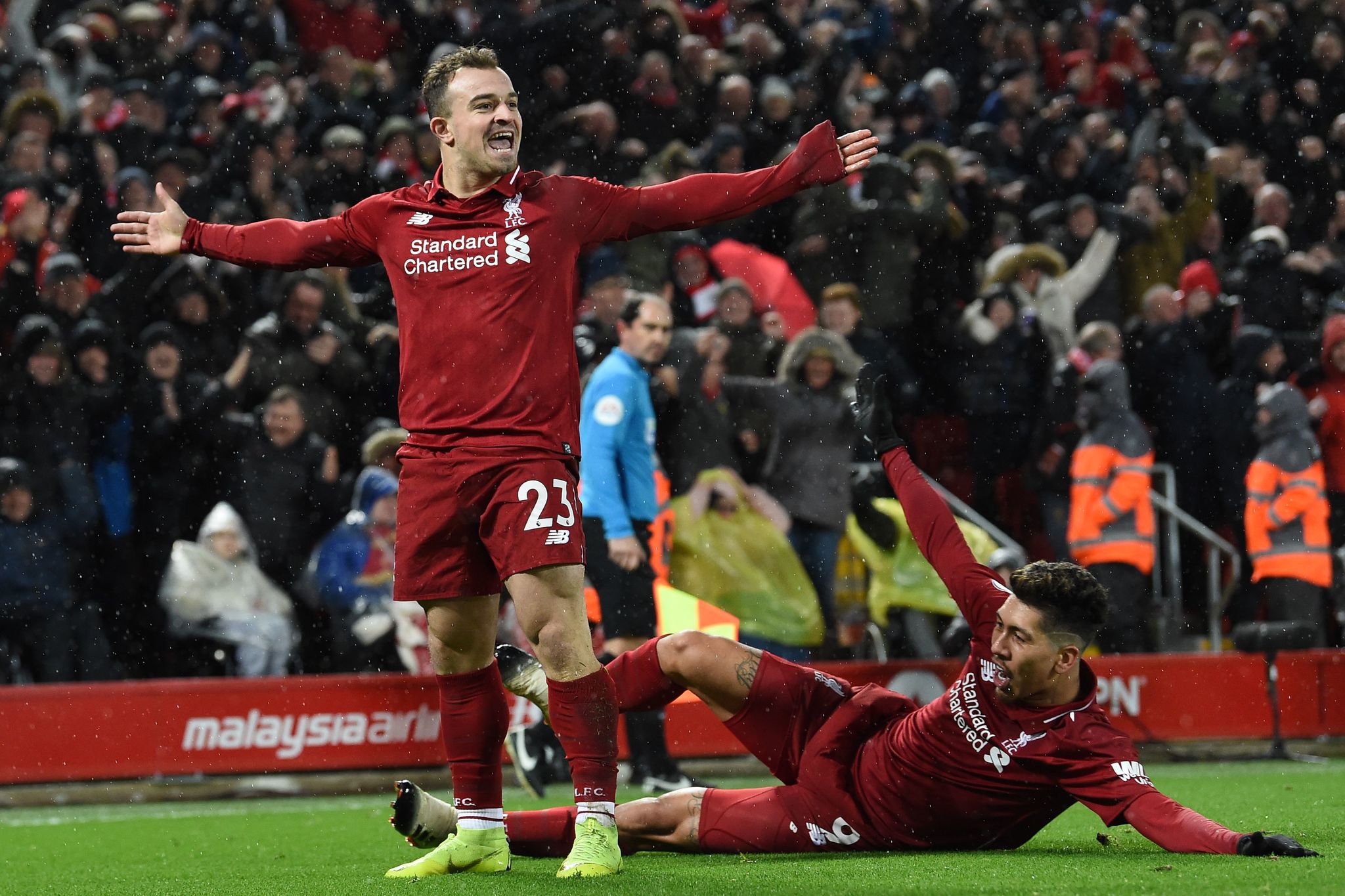 Liverpools Swiss midfielder Xherdan <HIT>Shaqiri</HIT> celebrates with Liverpools Brazilian midfielder Roberto Firmino (R) after scoring their second goal during the English Premier League football match between Liverpool and Manchester United at Anfield in Liverpool, north west England on December 16, 2018. (Photo by Paul ELLIS / AFP) / RESTRICTED TO EDITORIAL USE. No use with unauthorized audio, video, data, fixture lists, club/league logos or live services. Online in-match use limited to 120 images. An additional 40 images may be used in extra time. No video emulation. Social media in-match use limited to 120 images. An additional 40 images may be used in extra time. No use in betting publications, games or single club/league/player publications. /