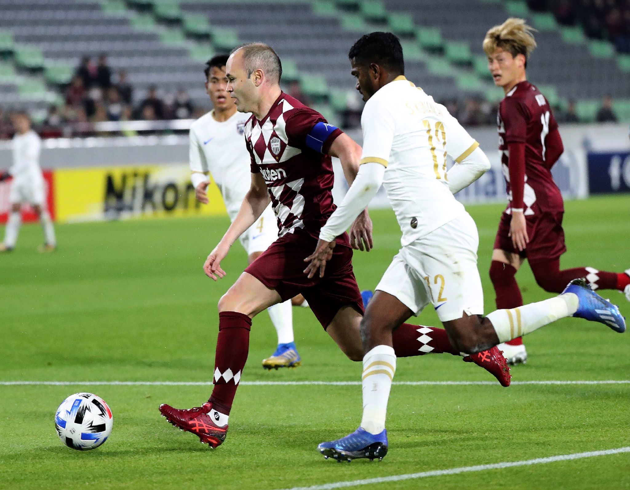 Vissel Kobe midfielders Andrs lt;HIT gt;Iniesta lt;/HIT gt; (L) fight for the ball with Johor Darul Tazim defender Kunanlan Subramaniam (2nd R) during the AFC Champions League group G football match between Japans Vissel Kobe and Malaysias Johor Darul Tazim at Misaki Park Stadium in Kobe, Hyogo prefecture on February 12, 2020. (Photo by STR / JIJI PRESS / AFP) / Japan OUT