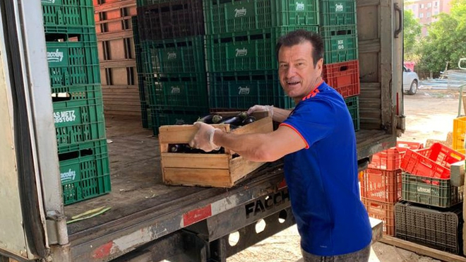 Dunga helps to carry food from a truck.