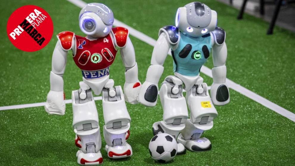 Two NAO robots compete for a ball.