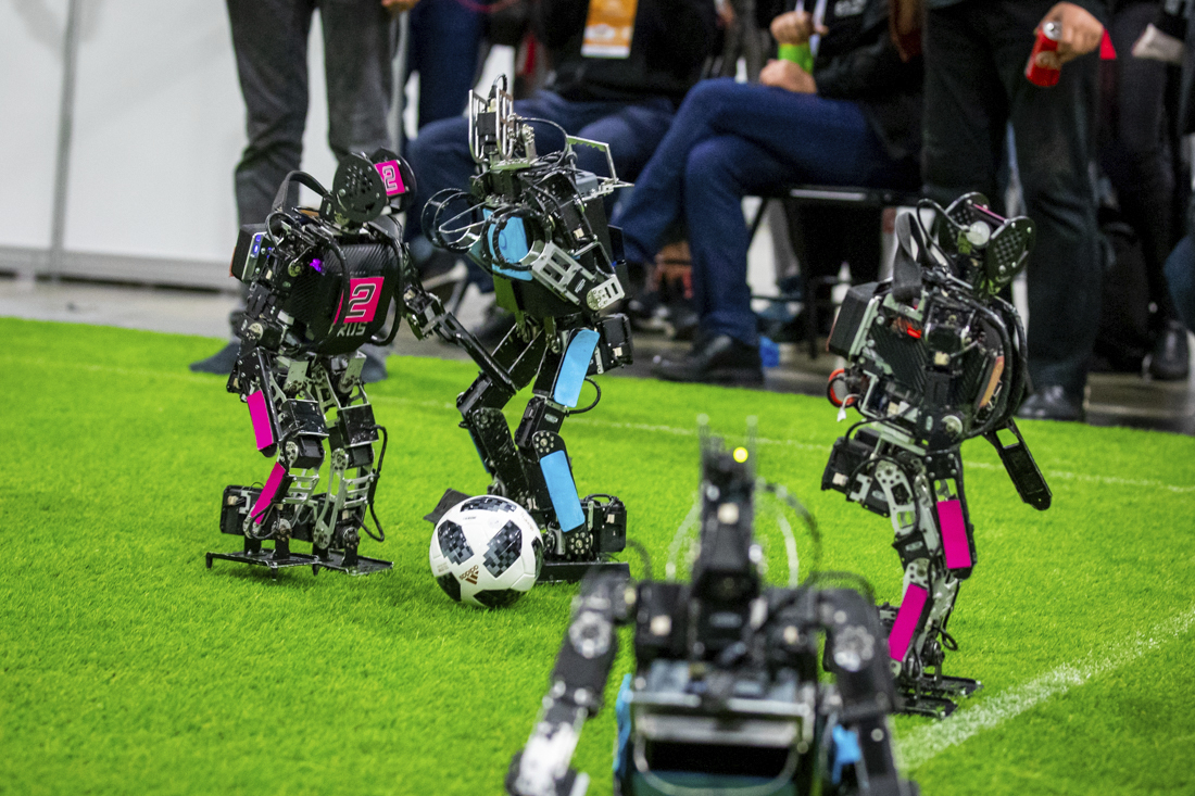 A battle for the ball in the RoboCup.