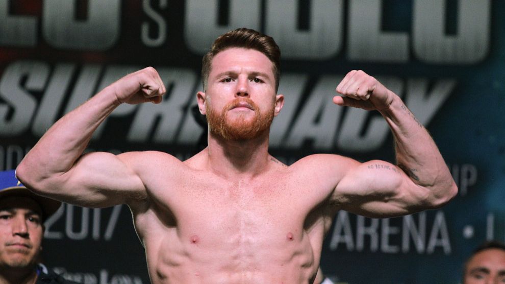 (FILES) In this file photo taken on September 15, 2017 boxer lt;HIT gt;Canelo lt;/HIT gt; Alvarez poses on the scales during a weigh-in with Gennady Golovkin at the MGM Grand Hotel Casino in Las Vegas, Nevada. Mexican middleweight Saul " lt;HIT gt;Canelo lt;/HIT gt;" Alvarez was temporarily suspended by Nevada boxing authorities on Friday, March 23, 2018, over positive drug tests, putting his May 5th title rematch with Gennady Golovkin in jeopardy. / AFP PHOTO / John GURZINSKI