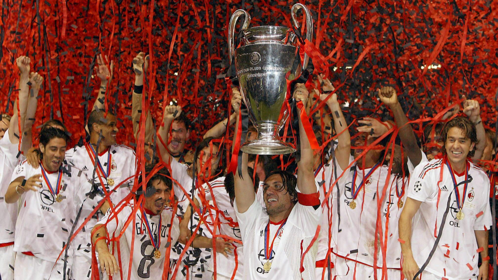  Paolo Maldini holds the Champions League trophy aloft as his teammates celebrate around him.