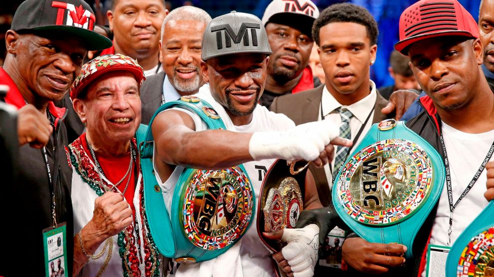 == FOR NEWSPAPERS, INTERNET, TELCOS    TELEVISION USE ONLY == LAS VEGAS, NV - SEPTEMBER 12: (L-R) Floyd lt;HIT gt;Mayweather lt;/HIT gt; Sr., Rafael Garcia, Floyd lt;HIT gt;Mayweather lt;/HIT gt; Jr. and Blake DeJuan pose in the ring following their WBC/WBA welterweight title fight against Andre Berto at MGM Grand Garden Arena on September 12, 2015 in Las Vegas, Nevada. lt;HIT gt;Mayweather lt;/HIT gt; won by unanimous decision. Ezra Shaw/Getty Images/AFP