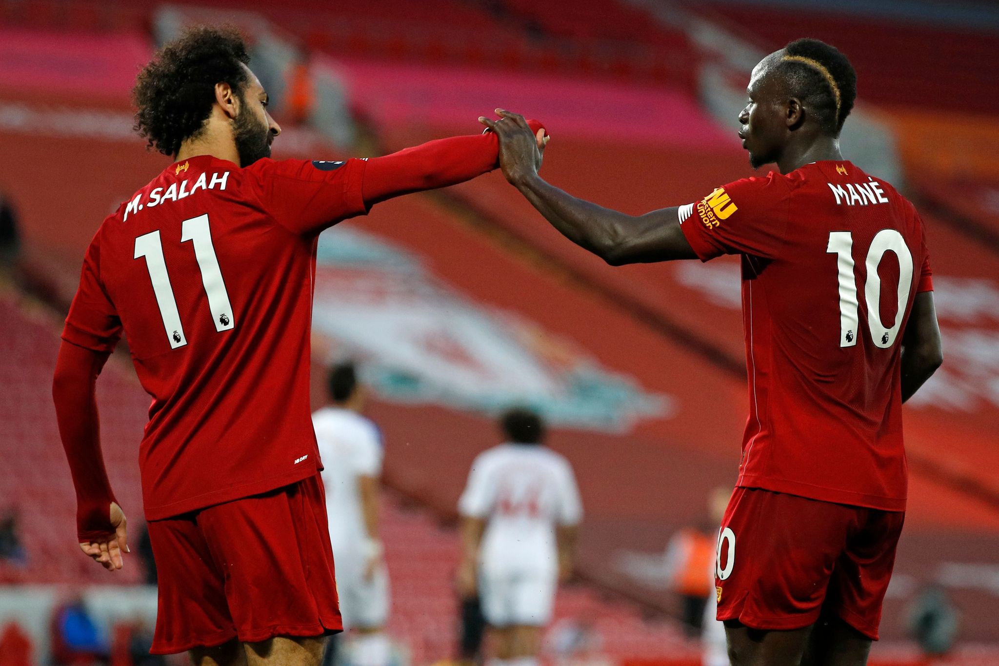 Liverpools Senegalese striker Sadio Mane (R) celebrates scoring his teams fourth lt;HIT gt;goal lt;/HIT gt; with Liverpools Egyptian midfielder Mohamed lt;HIT gt;Salah lt;/HIT gt; during the English Premier League football match between Liverpool and Crystal Palace at Anfield in Liverpool, north west England on June 24, 2020. (Photo by PHIL NOBLE / POOL / AFP) / RESTRICTED TO EDITORIAL USE. No use with unauthorized audio, video, data, fixture lists, club/league logos or live services. Online in-match use limited to 120 images. An additional 40 images may be used in extra time. No video emulation. Social media in-match use limited to 120 images. An additional 40 images may be used in extra time. No use in betting publications, games or single club/league/player publications. /