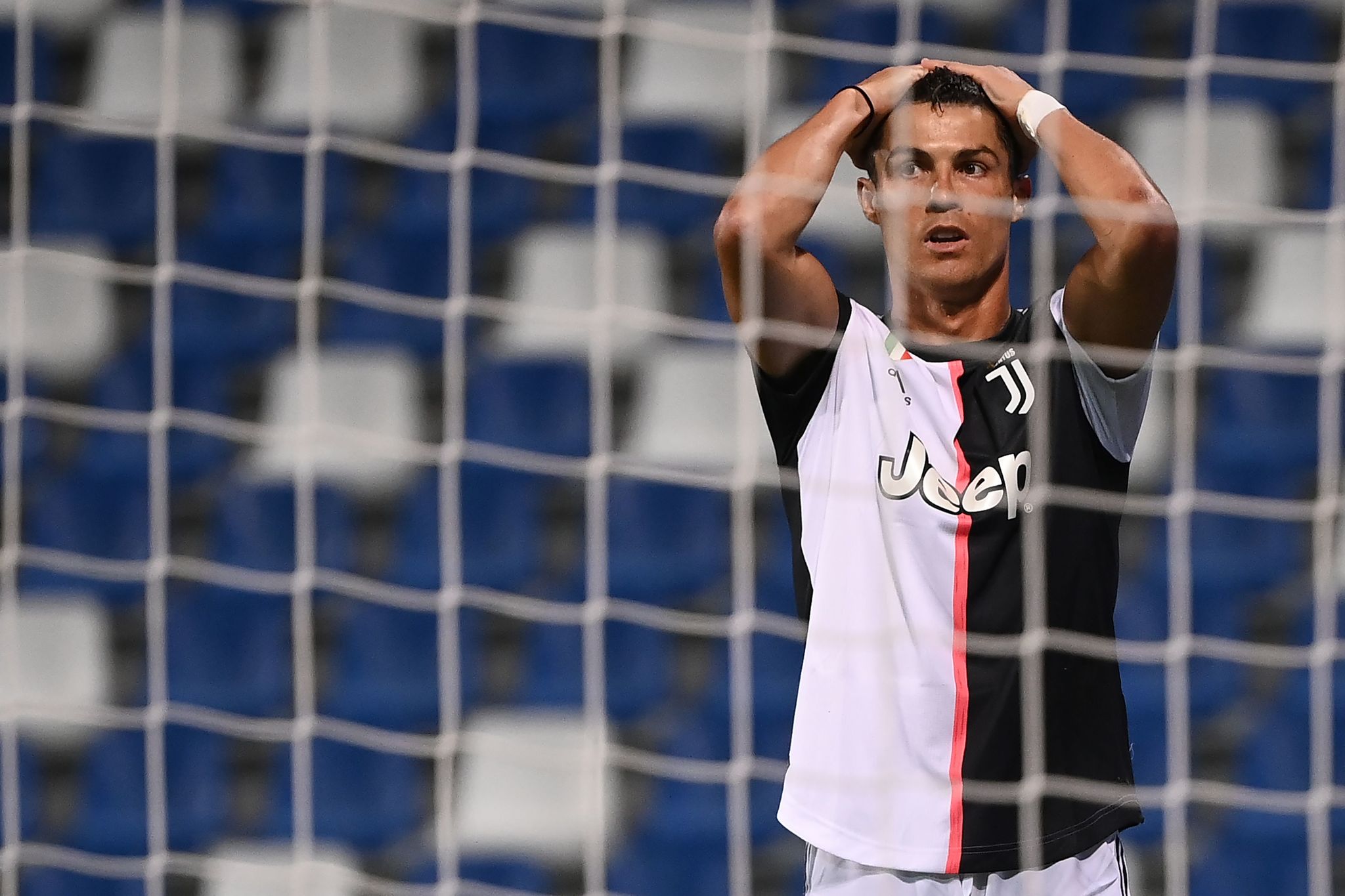 Juventus Portuguese forward lt;HIT gt;Cristiano lt;/HIT gt; Ronaldo reacts after missing a goal opportunity during the Italian Serie A football match between Sassuolo and Juventus Turin played behind closed doors on July 15, 2020 at the Mapei stadium in Reggio Emilia. (Photo by MARCO BERTORELLO / AFP)