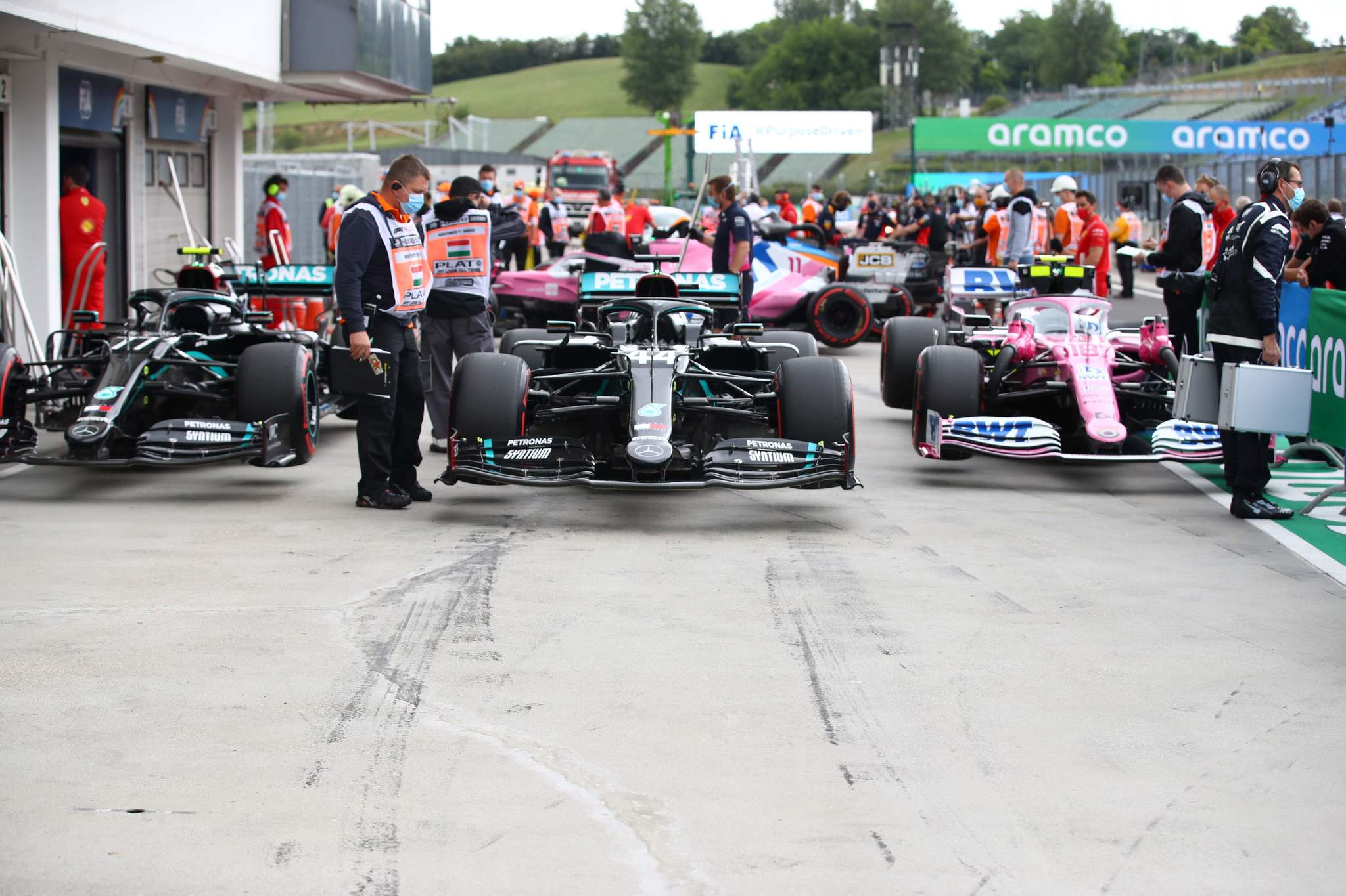 The cars of (L-R) Mercedes Finnish driver Valtteri Bottas, Mercedes British driver Lewis Hamilton and lt;HIT gt;Racing lt;/HIT gt; lt;HIT gt;Point lt;/HIT gt;s Canadian driver Lance Stroll are lined up after the qualifying session for the Formula One Hungarian Grand Prix at the Hungaroring circuit in Mogyorod near Budapest, Hungary, on July 18, 2020. (Photo by Mark Thompson / POOL / AFP)