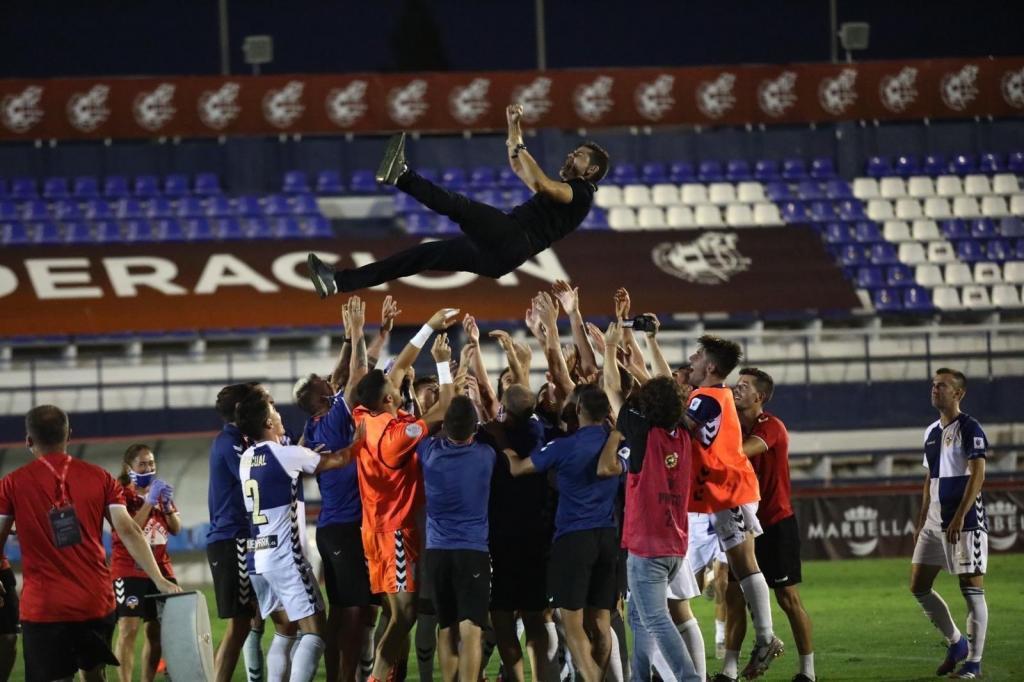 Antonio Hidalgo lifted up by his players after sealing promotion.