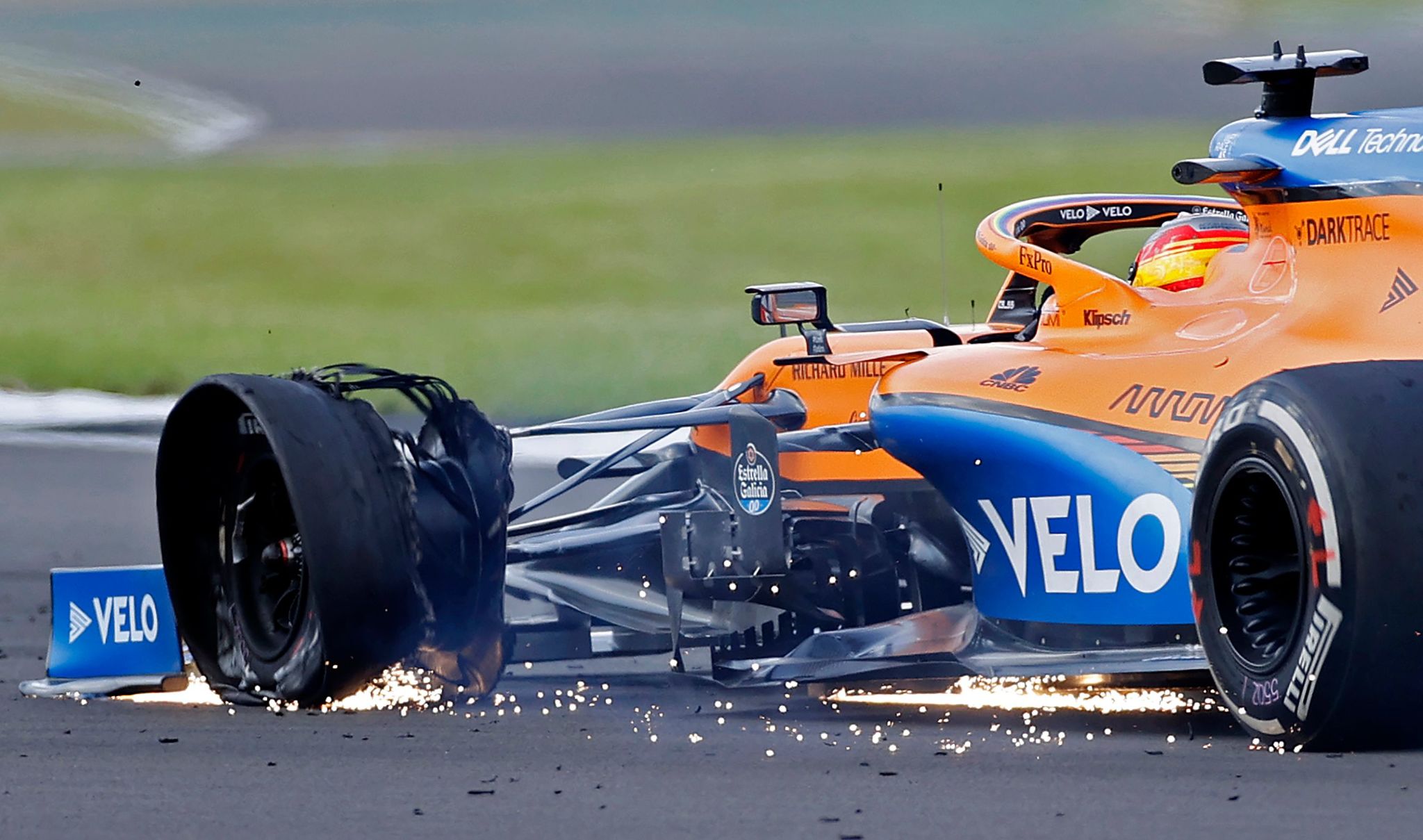 The punctured tyre of McLarens Spanish driver lt;HIT gt;Carlos lt;/HIT gt; lt;HIT gt;Sainz lt;/HIT gt; Jr is picture as he nears the finish of the Formula One British Grand Prix at the Silverstone motor racing circuit in Silverstone, central England on August 2, 2020. - Lewis Hamilton survived a dramatic finale to win the British Grand Prix on Sunday, just making it across the line on three tyres to beat a fast closing Max Verstappen on Red Bull. The defending world champion claimed his seventh British Grand Prix win as Ferarris Charles Leclerc came third and Daniel Ricciardo of Renault fourth. (Photo by ANDREW BOYERS / POOL / AFP)
