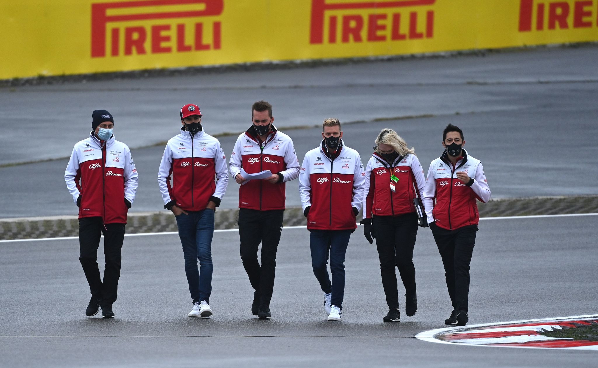 Alfa Romeo's German driver lt;HIT gt;Mick lt;/HIT gt; lt;HIT gt;Schumacher lt;/HIT gt; (3rd R) and team members inspect the circuit ahead of the Formula One - Eifel Grand Prix at the Nuerburgring circuit in Nuerburg, western Germany, on October 8, 2020. (Photo by Ina FASSBENDER / AFP)