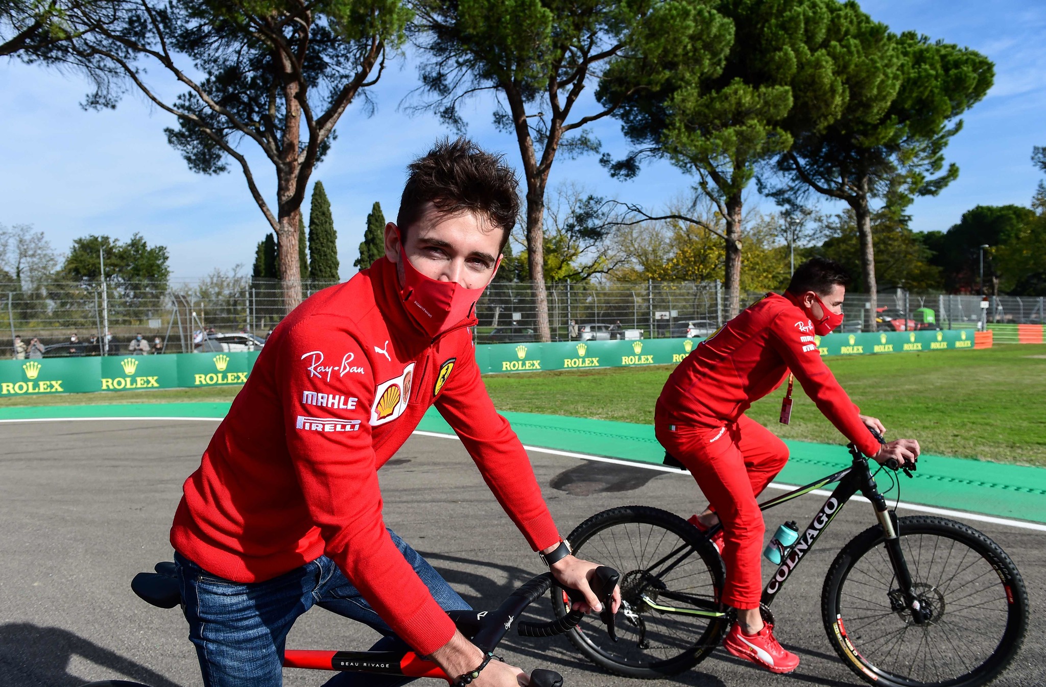 Ferrari's Monegasque driver Charles lt;HIT gt;Leclerc lt;/HIT gt; (L) rides a bike as he inspects the Autodromo Internazionale Enzo e Dino Ferrari race track in Imola, Italy, on October 30, 2020, two days ahead of the Formula One Emilia Romagna Grand Prix. (Photo by Miguel MEDINA / AFP)