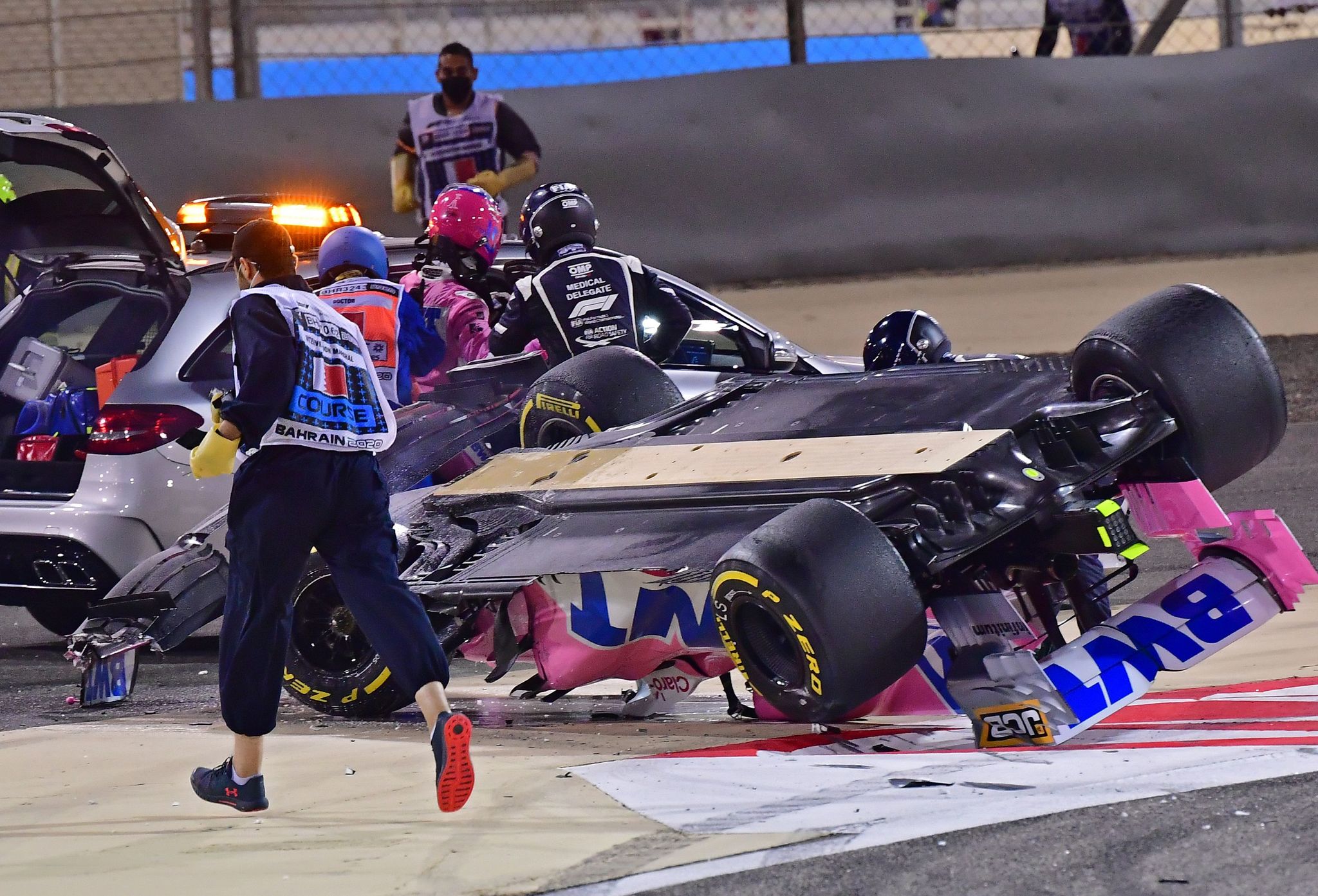 Racing Point's Canadian driver Lance lt;HIT gt;Stroll lt;/HIT gt; (2nd-R) is helped into the medical car after crashing during the Bahrain Formula One Grand Prix at the Bahrain International Circuit in the city of Sakhir on November 29, 2020. (Photo by Giuseppe CACACE / POOL / AFP)